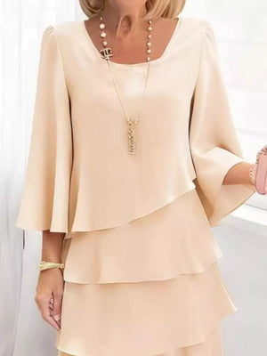 Elegant tiered dress in tan with 3/4 bell sleeves and a square neckline.