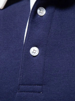 Navy long sleeve polo shirt with white collar trim and two button placket.