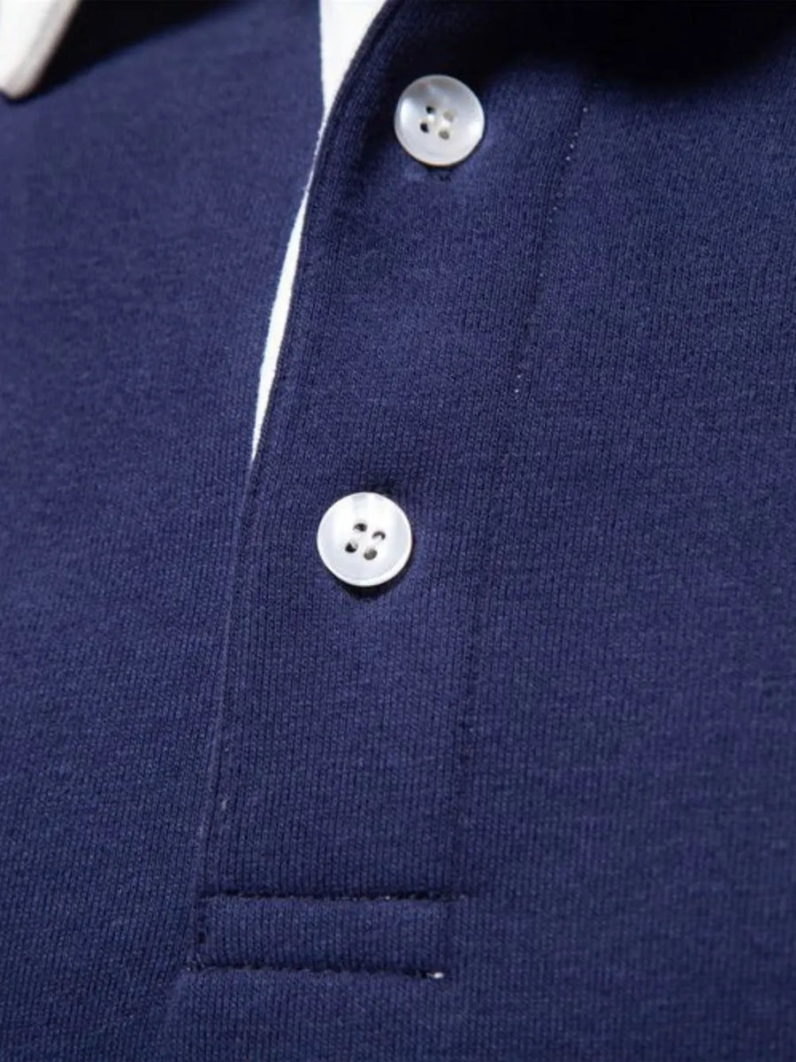 Navy long sleeve polo shirt with white collar trim and two button placket.