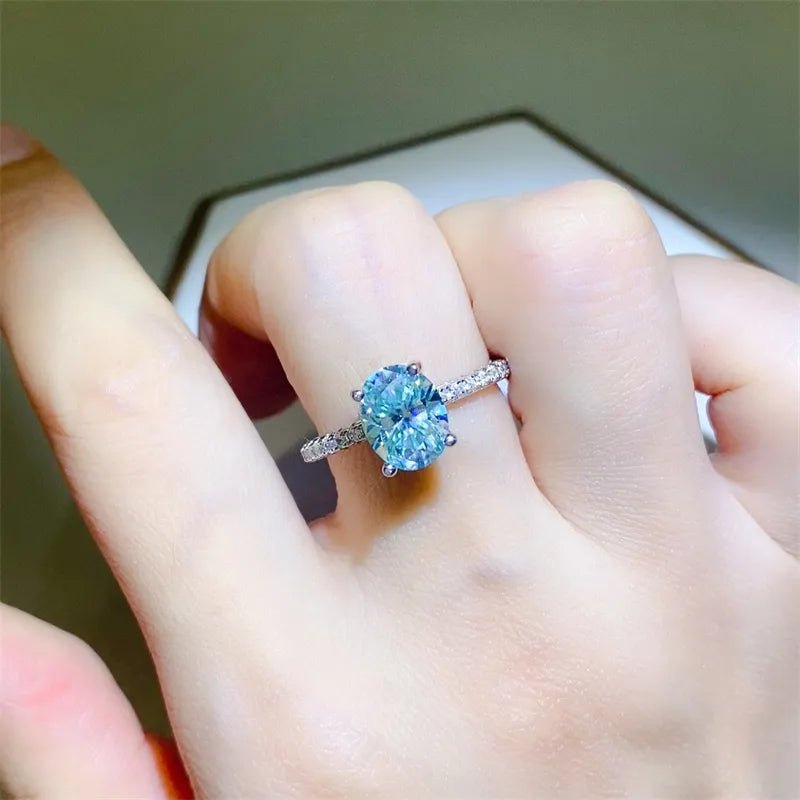 Silver moissanite pavé band ring with oval aqua center stone