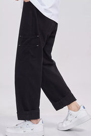 Relaxed fit black cargo sweatpants with cuffed hems and visible stitching detail on pockets.