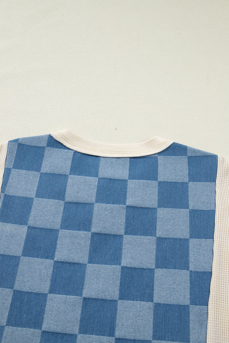 Maternity T-shirt with blue checkered denim front and cream waffle knit sleeves.