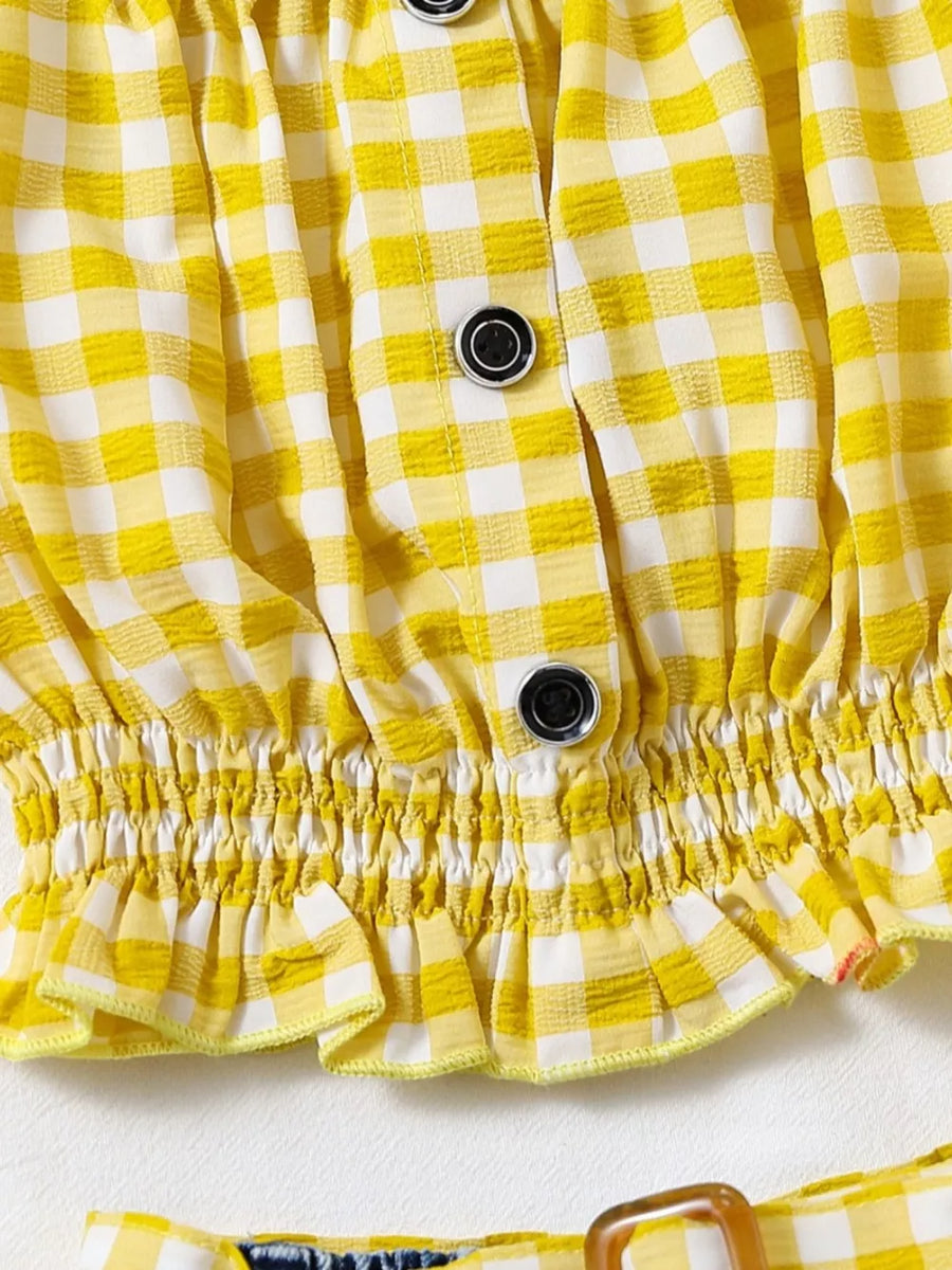 Yellow gingham baby top with button front and ruffled hem, paired with denim shorts.