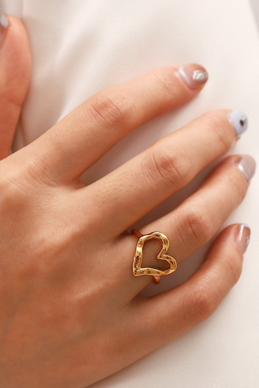 Gold sculpted heart signet ring with textured finish