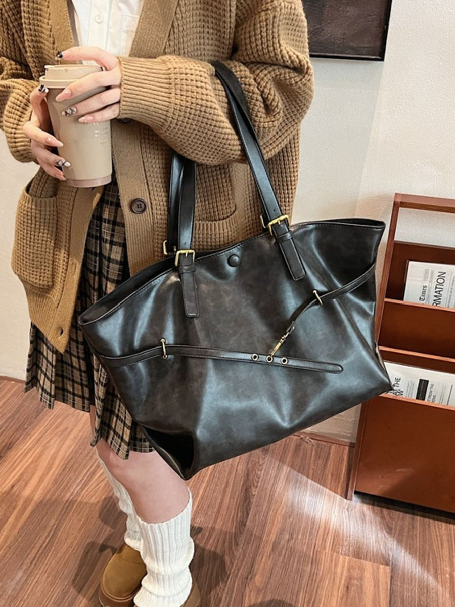 tote in dark gray featuring adjustable straps and loose fit