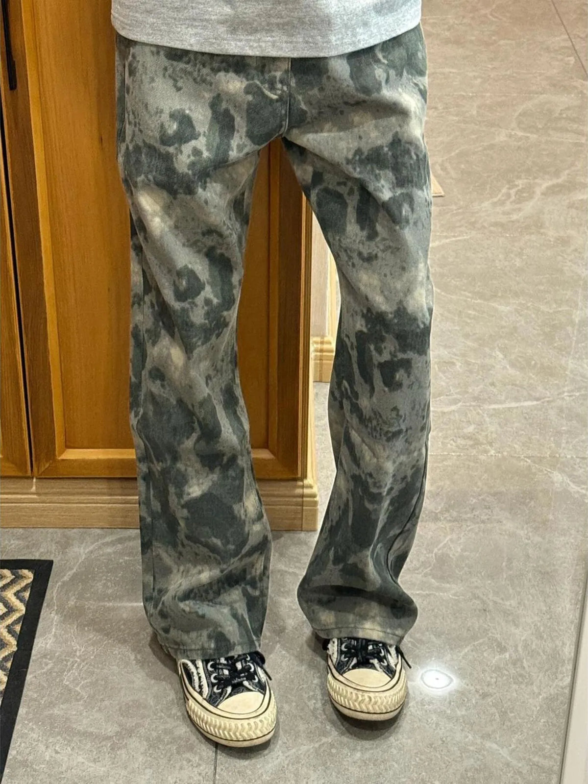 Men's loose fit cargo pants in moss green camouflage pattern, casual wear.