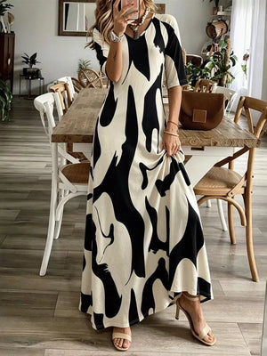Maxi dress with abstract print, V-neck, short sleeves, and flowy skirt.