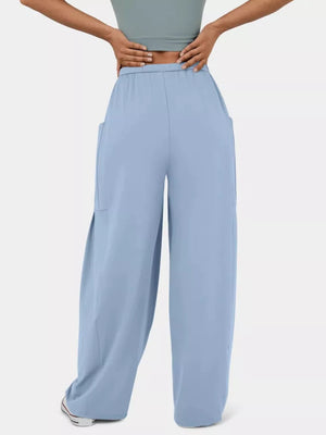 Light Blue maternity pants with wide legs and pockets, styled with a crop top.
