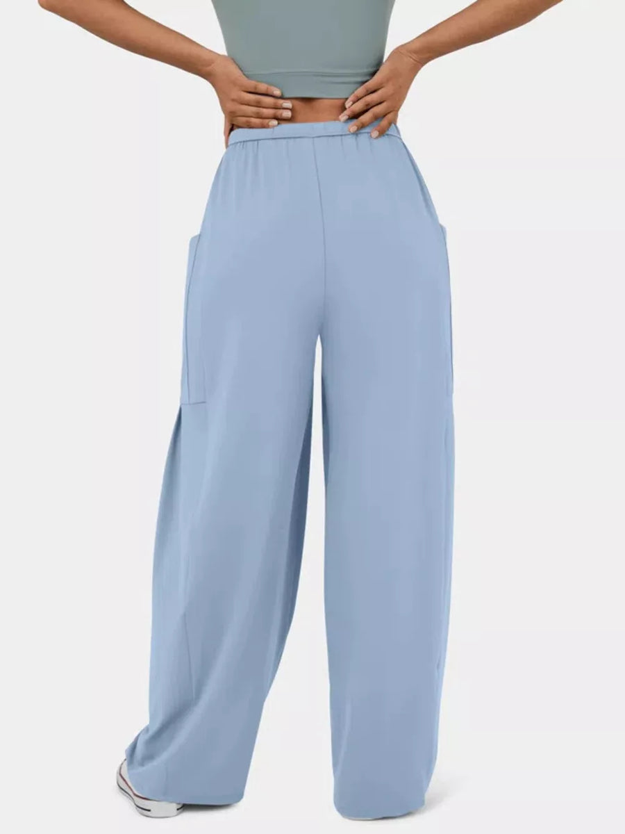 Light Blue maternity pants with wide legs and pockets, styled with a crop top.