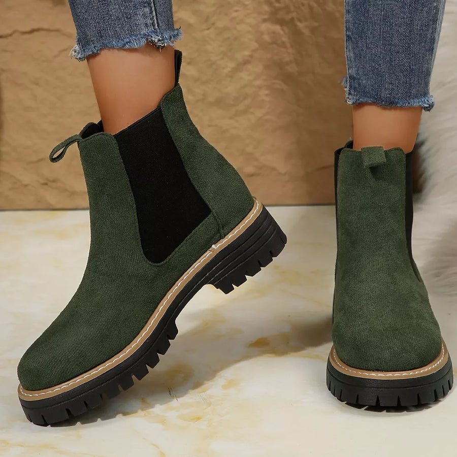 Green suede chelsea ankle boots with chunky sole and elastic sides.