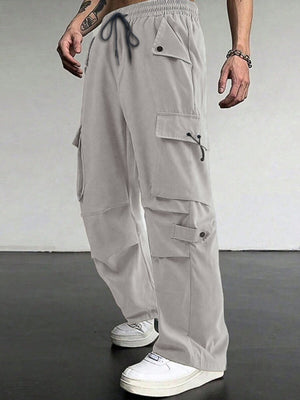 Light grey cargo pants with drawstring waist and multiple flap pockets.