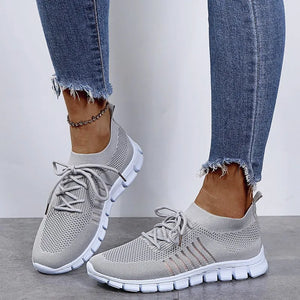 Gray knit runner sneakers with ribbed lace-up detail and white soles.