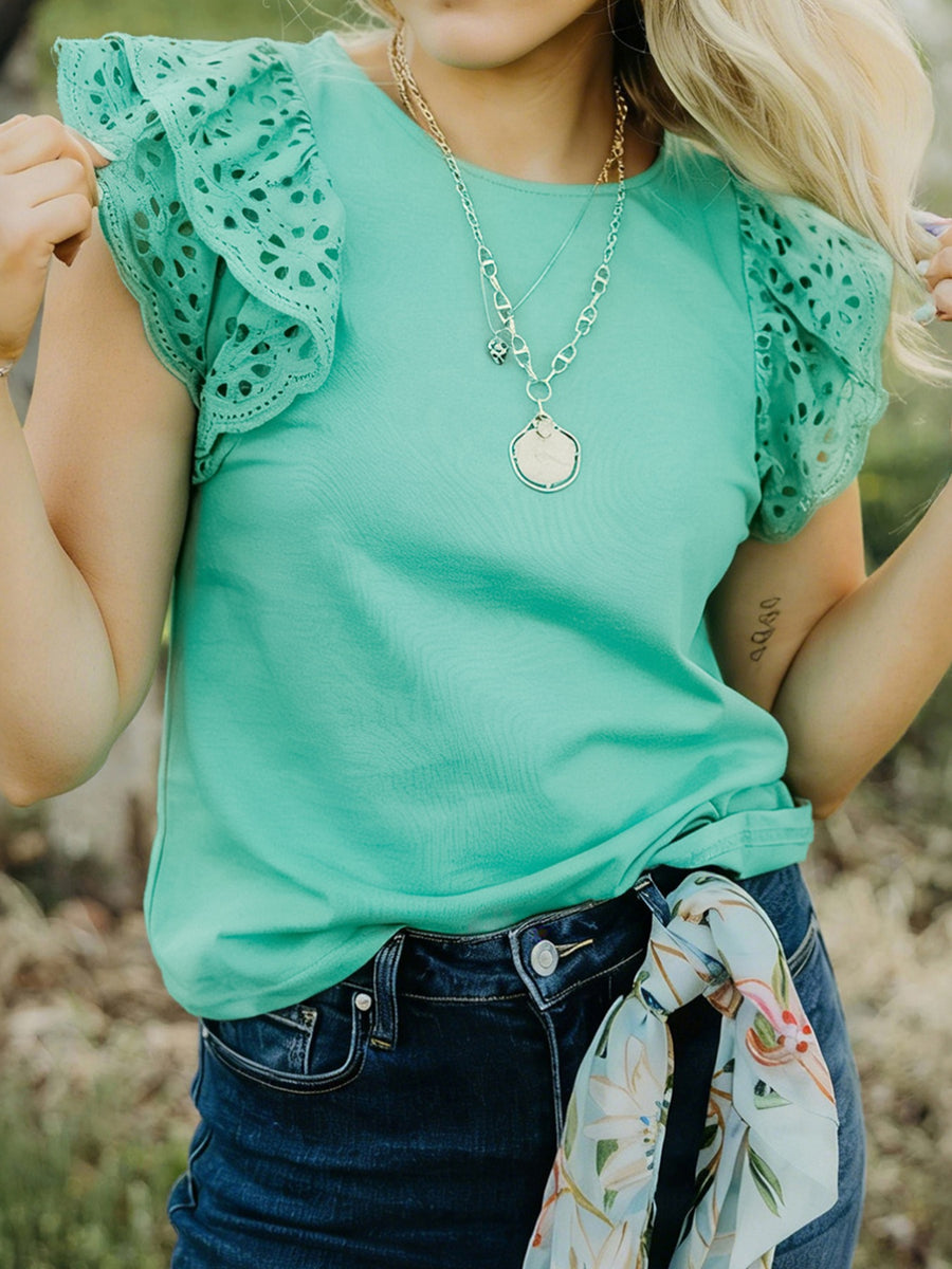 Green eyelet lace ruffled cap sleeve blouse with a round neckline.