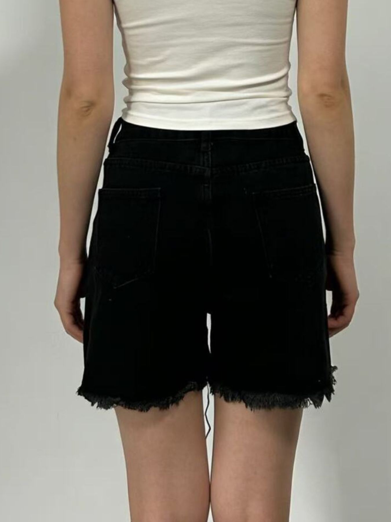 Black denim shorts with frayed hem and high rise