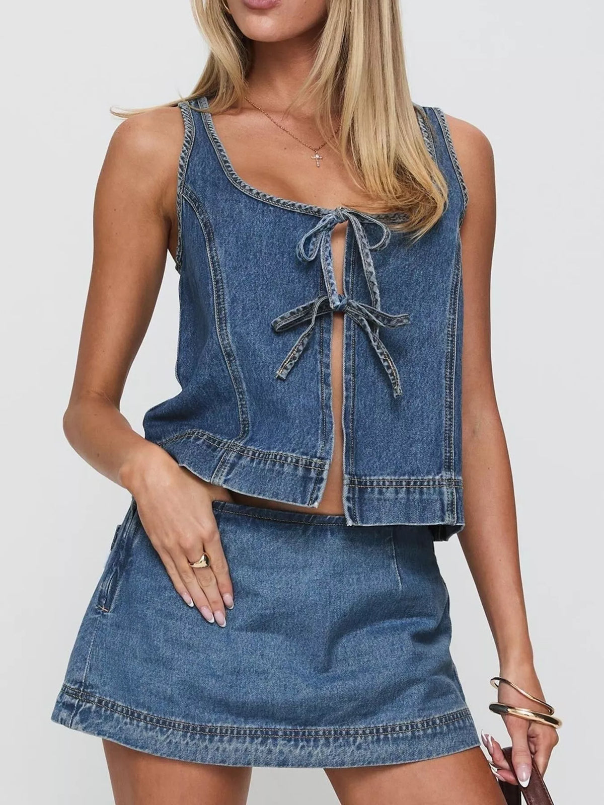 Blue denim tie-front tank top and mini skirt set with a scoop neckline.