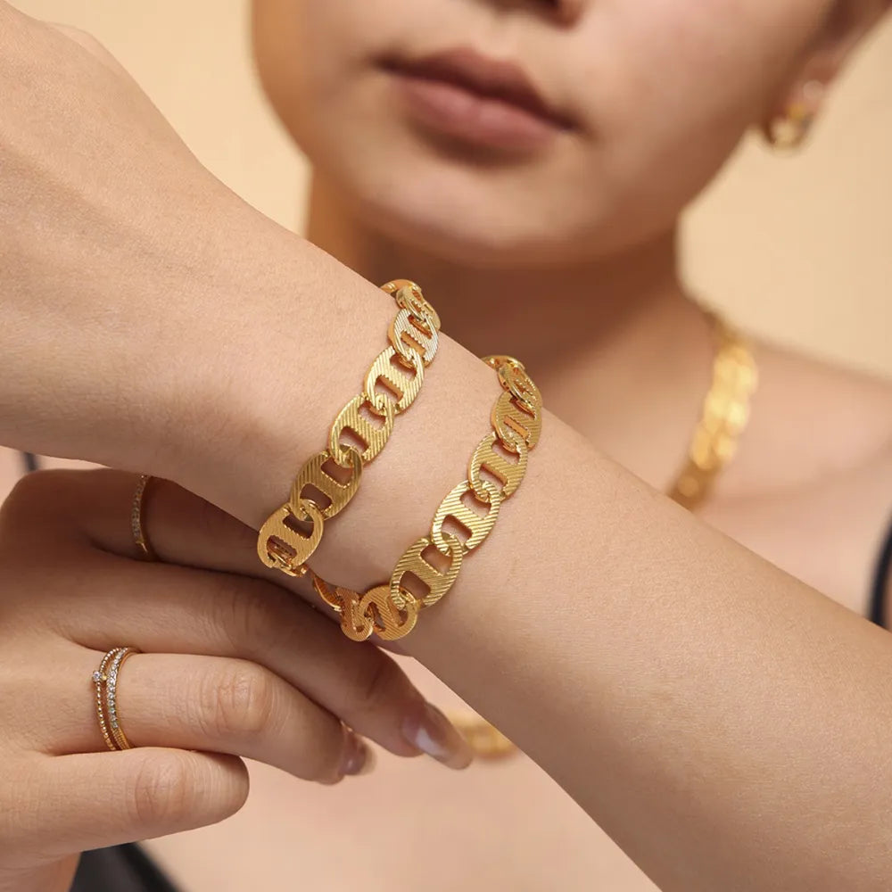 Textured gold oval link bracelet with a chic, casual style.
