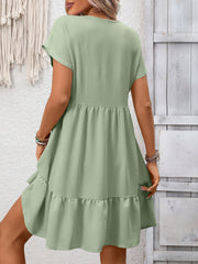 V-neck mini dress in Bean Green with short sleeves and a ruffled hem.