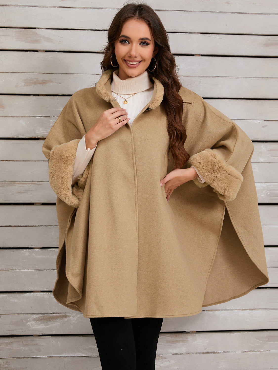 Tan cape coat with faux fur trim on collar and cuffs, open front style.
