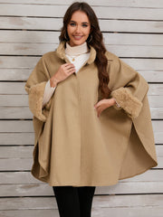 Tan cape coat with faux fur trim on collar and cuffs, open front style.