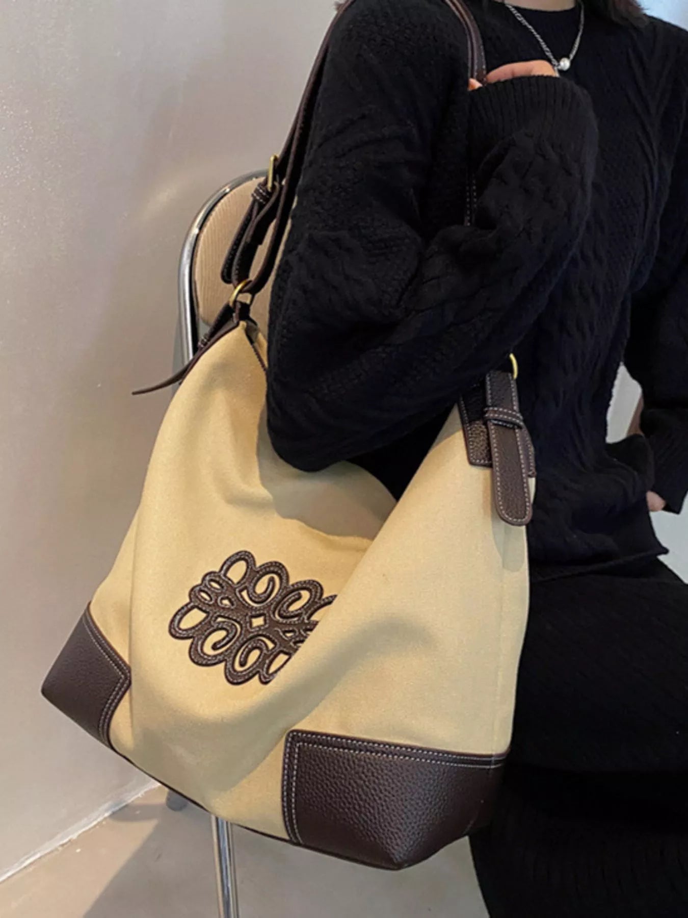 Embroidered medium canvas tote bag in khaki with brown trim and detail.