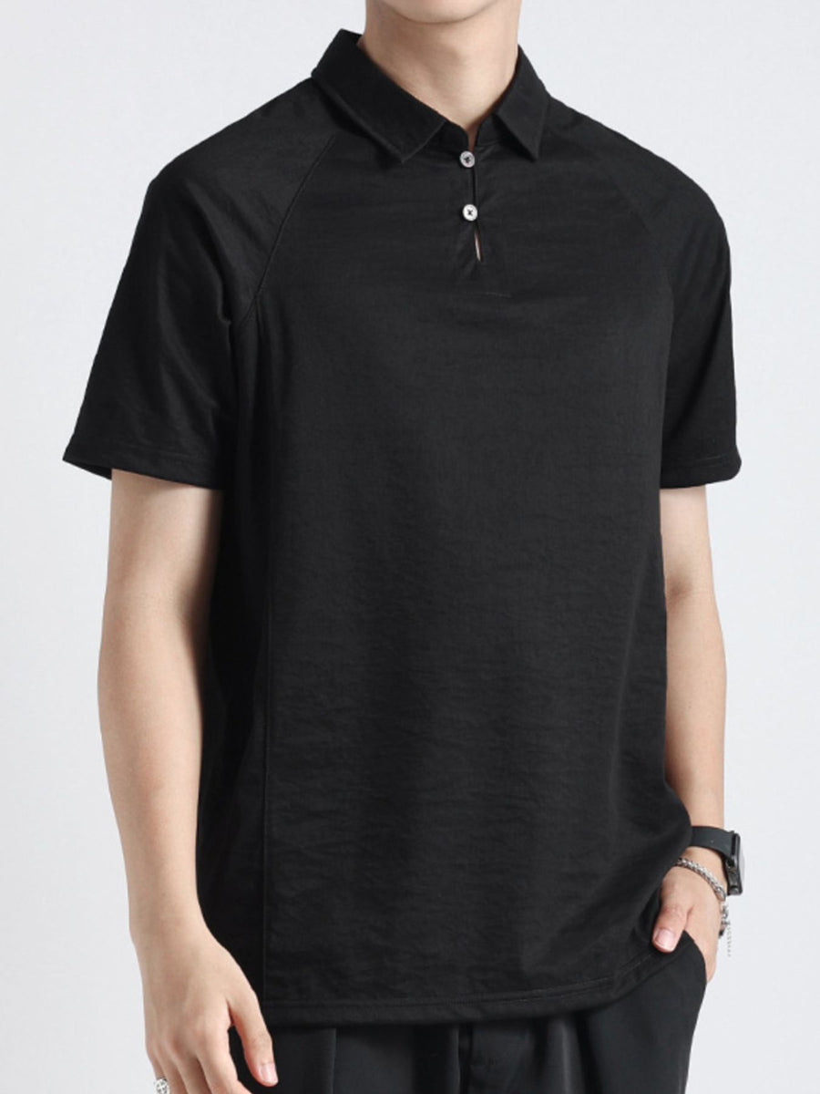 Black cotton blend polo shirt with short sleeves and a two-button placket.