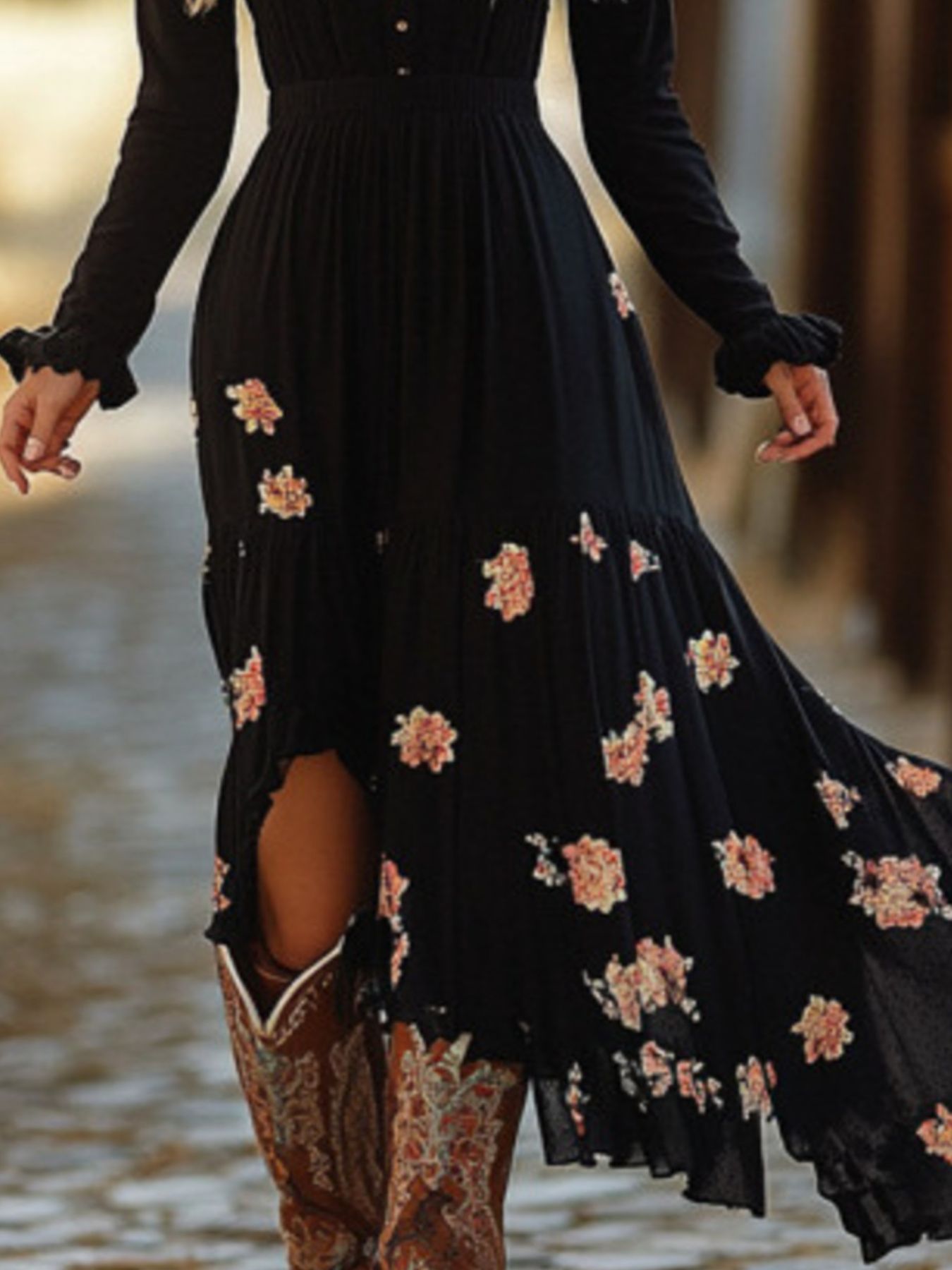Black floral print maxi dress with decorative buttons and ruffled cuffs.