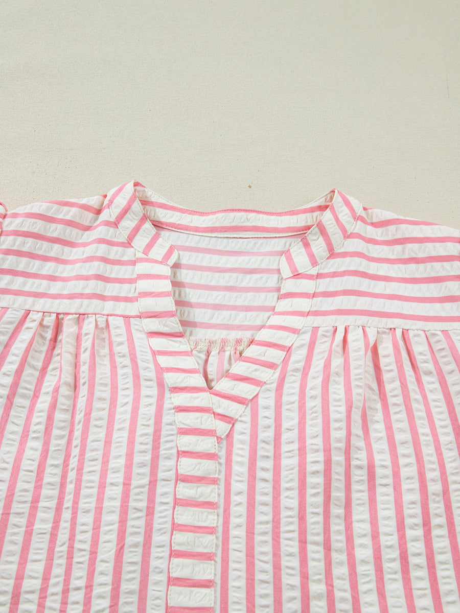 Pink and white striped seersucker blouse with V-neck and gathered yoke.
