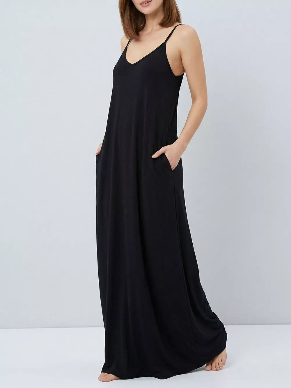 Black maxi dress with spaghetti straps and functional pockets.