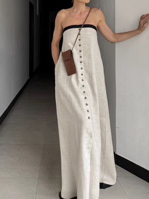 Button front tube maxi dress in beige cotton blend with black trim.