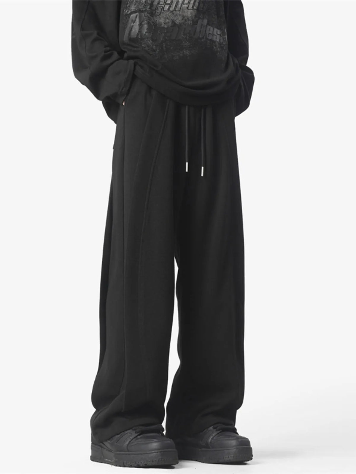Men's black loose fit drawstring pants with a comfortable cotton blend fabric.