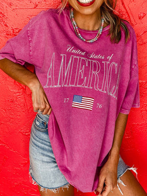 Patriotic graphic cotton t-shirt in pink with United States of America text and flag detail.