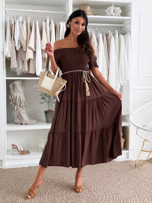 Dark brown smocked off-shoulder midi dress with tiered skirt and tassel belt.