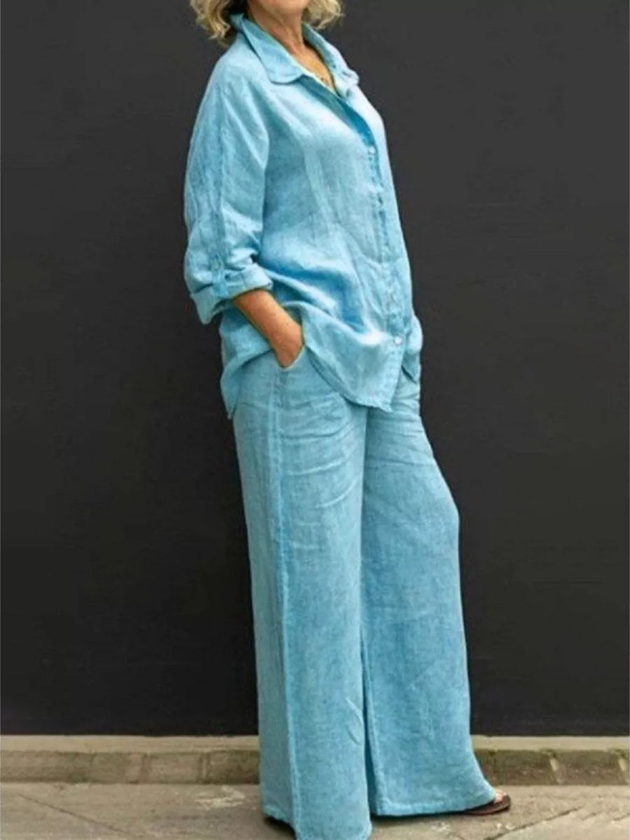 Sky blue button-down collared two-piece set with wide-leg pants and cuffed sleeves.