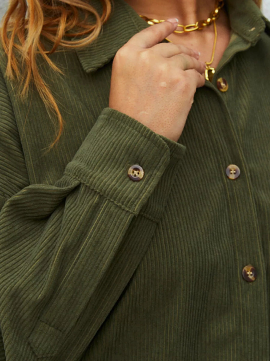 Olive green corduroy button-up shirt with visible buttons and cuff detail