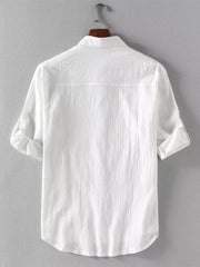 White casual button-up shirt with band collar and rolled sleeves.