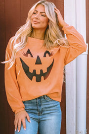 Caramel corduroy sweatshirt with a black jack-o'-lantern graphic and long sleeves.