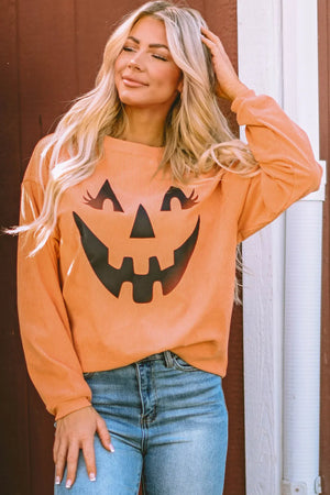 Caramel corduroy sweatshirt with a black jack-o'-lantern graphic and long sleeves.