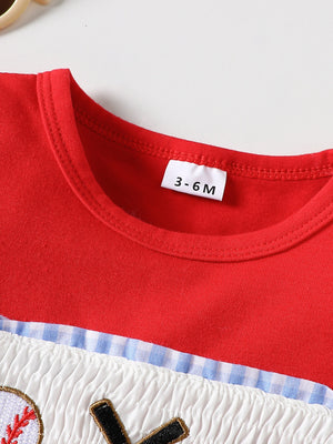 Red baseball graphic tee with smocked white fabric and blue gingham trim.