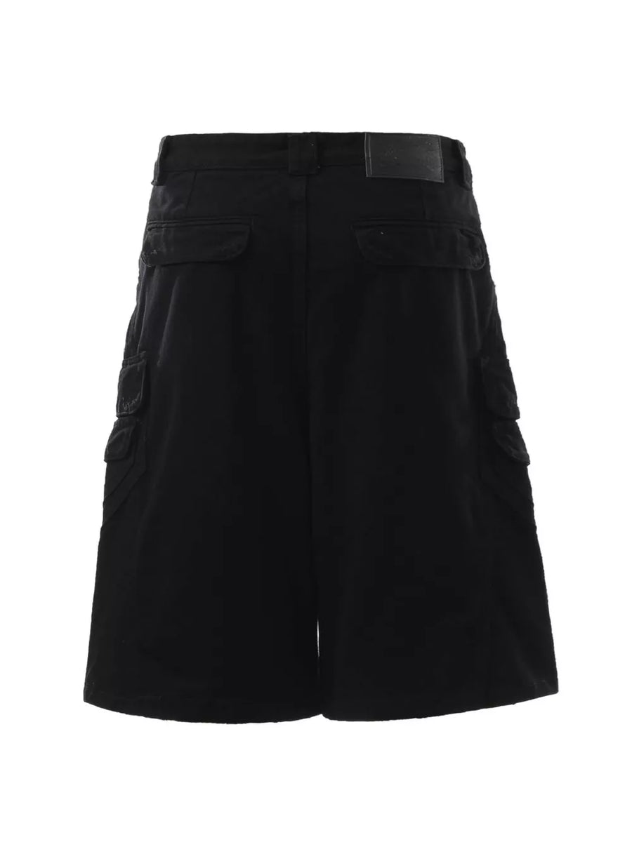 Black cargo capris for men with multiple pockets and a leather logo patch.