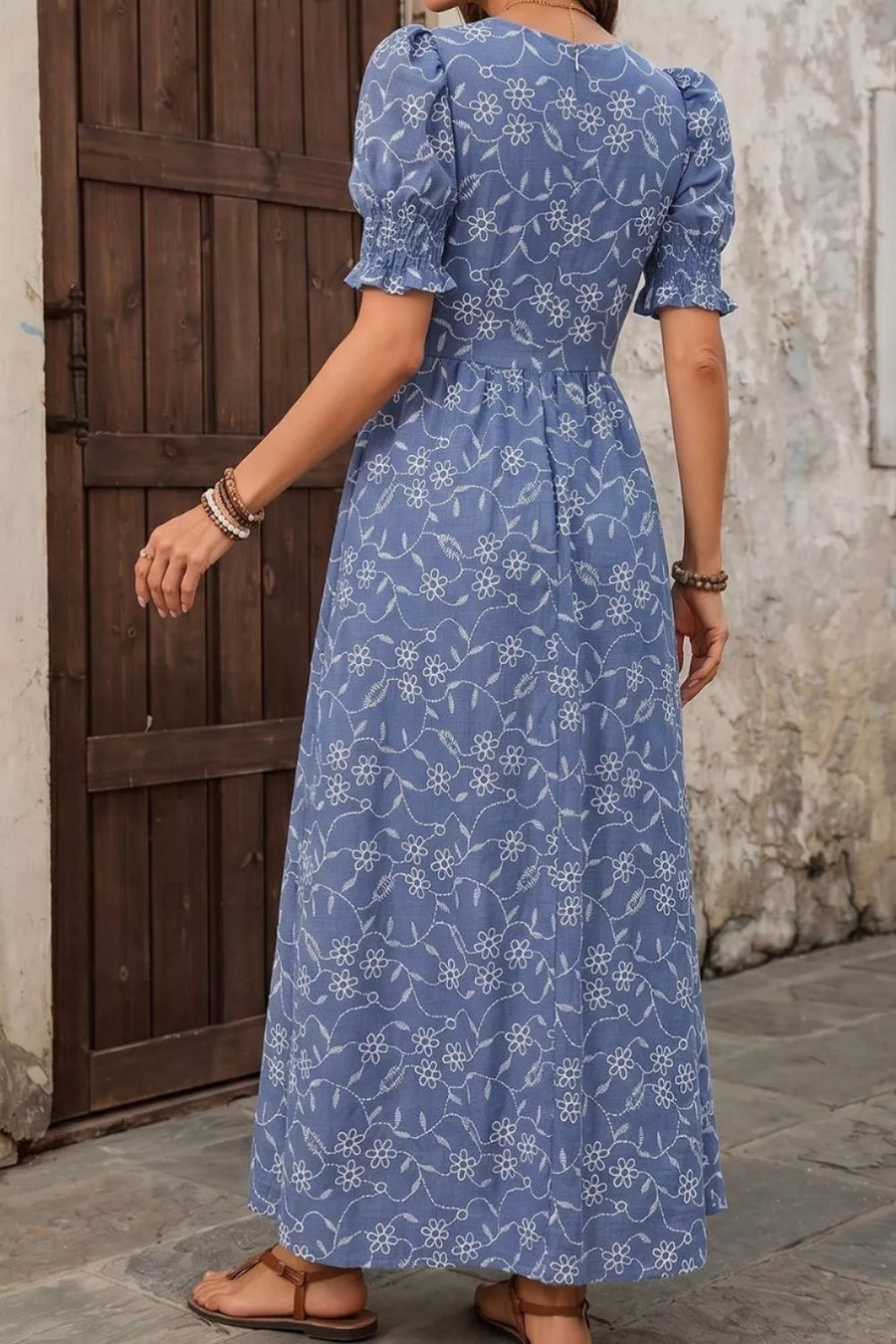 Blue floral embroidered maxi dress with puff sleeves and cinched waist.