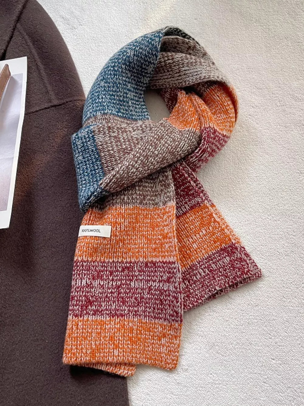 Textured wool color block scarf with blue, brown, orange, and burgundy stripes.