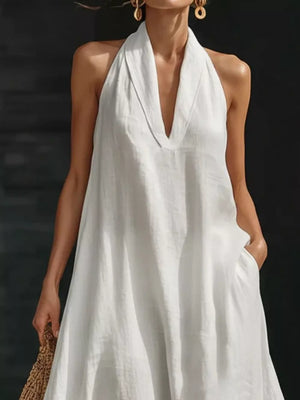 White halter neck maxi dress with pockets, deep V-neck, 100% polyester.