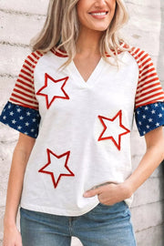 White t-shirt with red star appliques and ruffled flag-print sleeves.
