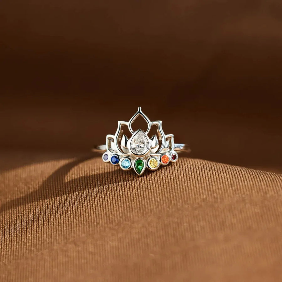 Sterling silver ring with lotus design and colorful chakra gemstones.