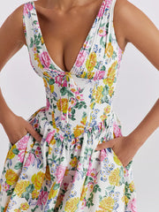 Floral print midi dress with V-neck and tie detail, featuring a-line skirt and pockets.