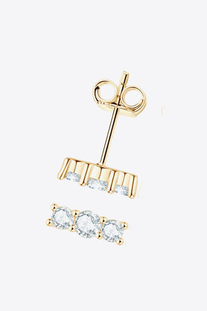 Gold triple stone bar stud earrings with clear cubic zirconia stones.