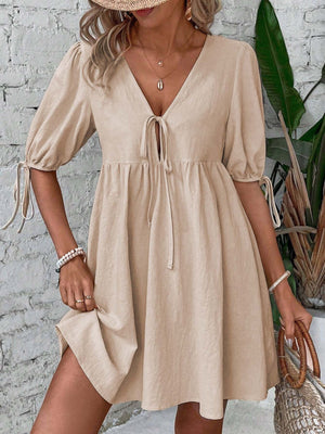 Beige tie front puff sleeve mini dress with adjustable tie cuffs and a-line cut