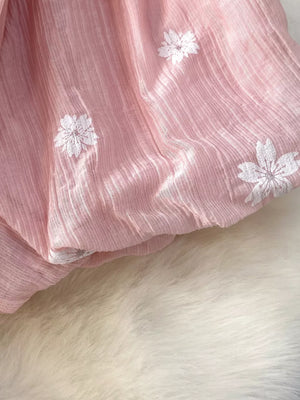 Dusty Pink midi dress with white floral embroidery and puff sleeves.