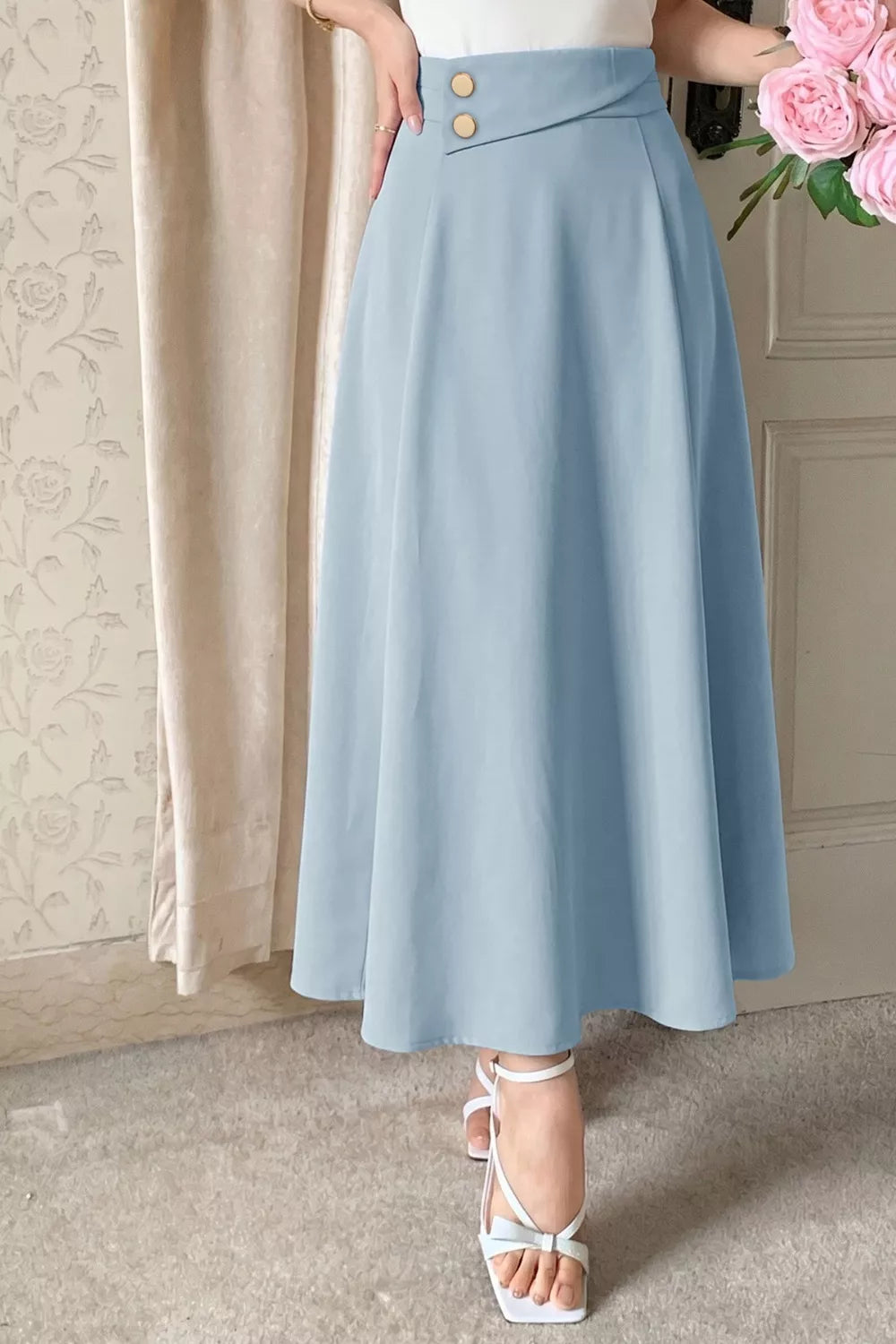 Light blue midi a-line skirt with asymmetrical button detail at waist