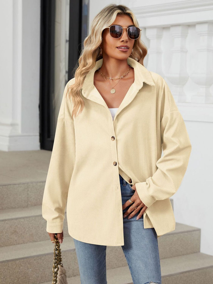 Oversized cream corduroy shirt jacket with button front and collar.